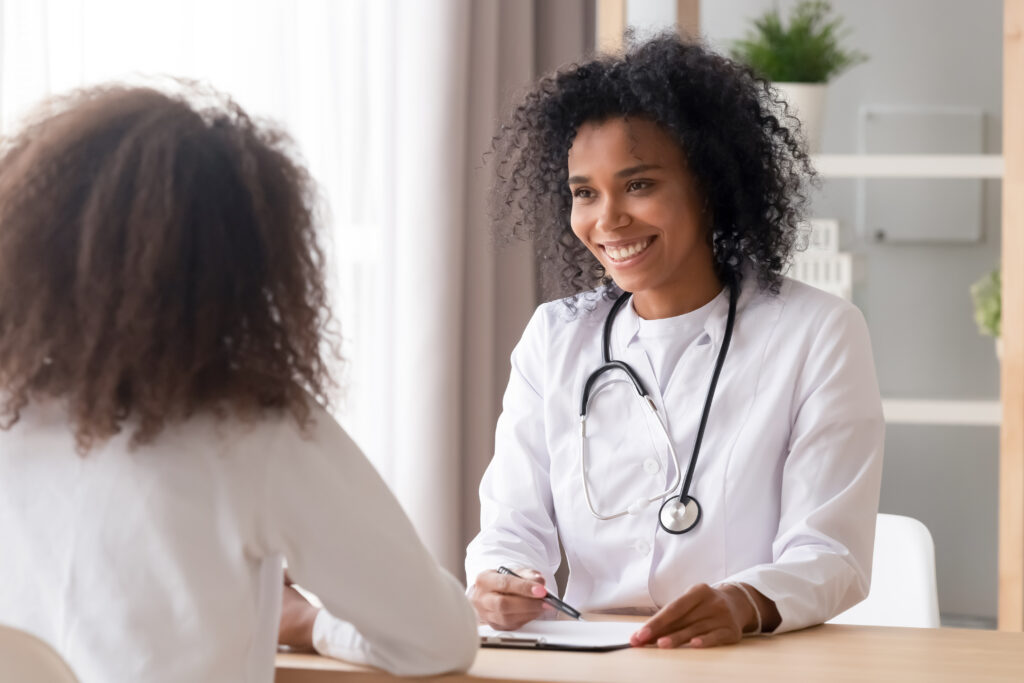 A psychiatrist discusses treatment plans with nurses and other healthcare professionals in a collaborative meeting, emphasizing teamwork in patient care.