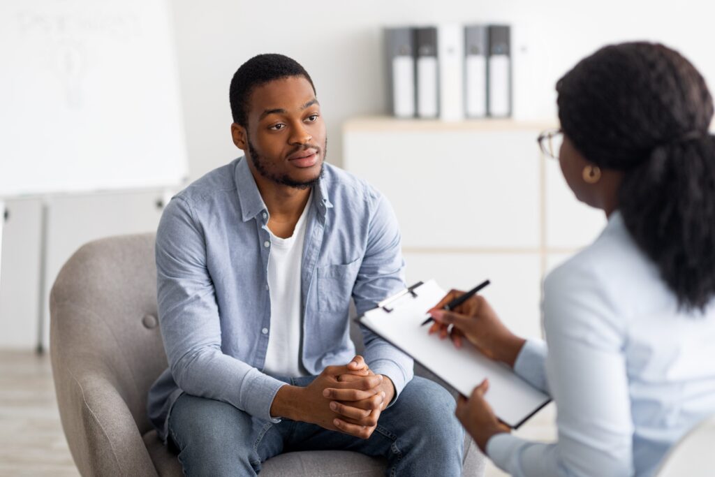 A psychiatrist examines medical files and notes on a clipboard, demonstrating the thoroughness and attention to detail required in psychiatric care.